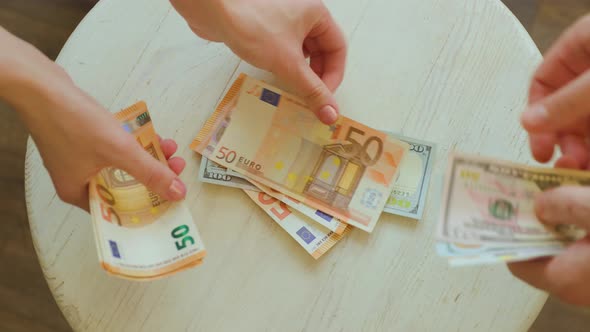 Hands Counting Euro Pound and Dollars Banknotes alt