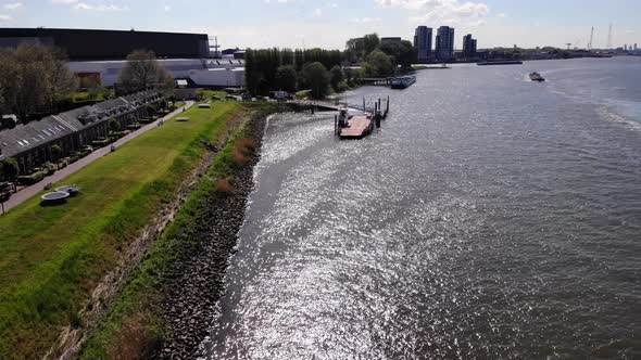 Green Lawn And A Small Port On The River In Kinderdijk Village In Molenlanden, South Holland. aerial alt