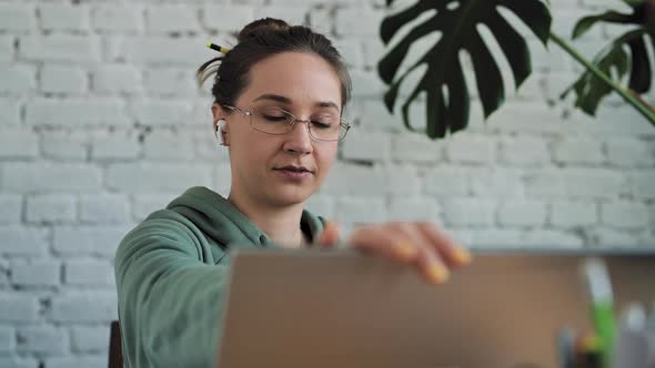White Woman in Glasses Working From Home Typing on Computer