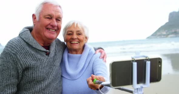 Senior couple taking a selfie from selfie stick alt
