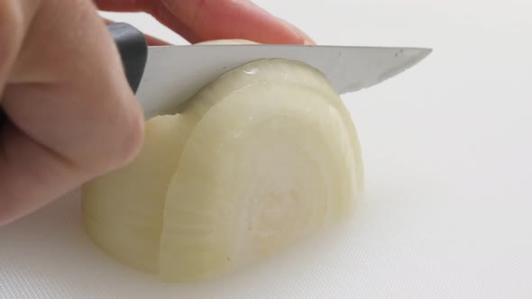 Organic common bulb onion chopping up with knife on white board 4K 2160p 30fps UHD footage - White A alt