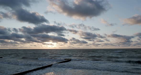 Breakwater of Larch Logs. Strengthening the Seashore To Keep the Sand on the Beach. Gorgeous Sunset alt