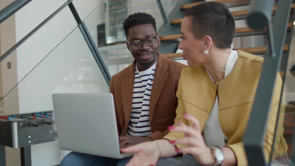 Handsome young African American business man and short hair woman working