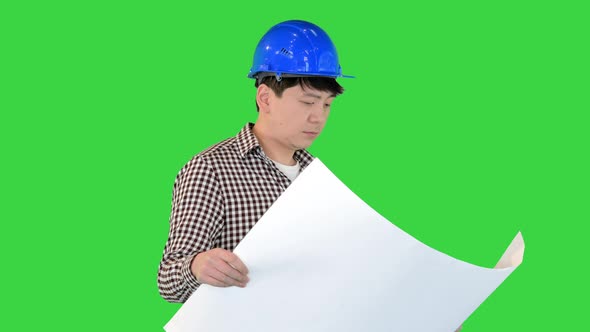 Engineer Walking and Looking at Blueprint on a Green Screen Chroma Key alt