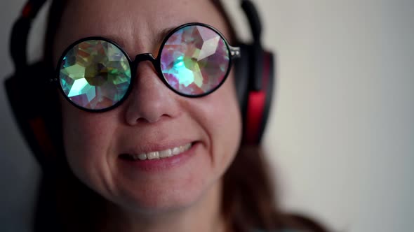 Closeup of a Woman with Glasses Crystals in Place of Glasses Having Fun Listening to Music with alt
