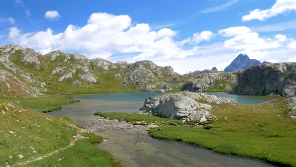 PAN: Idyllic blue alpine lake high up on the mountains, scenic landscape rocky terrain at high altit alt
