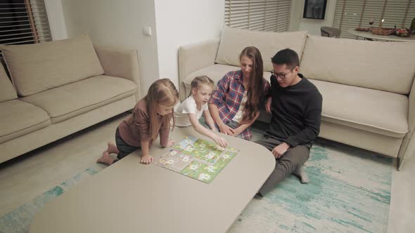 Family spends time together playing board games