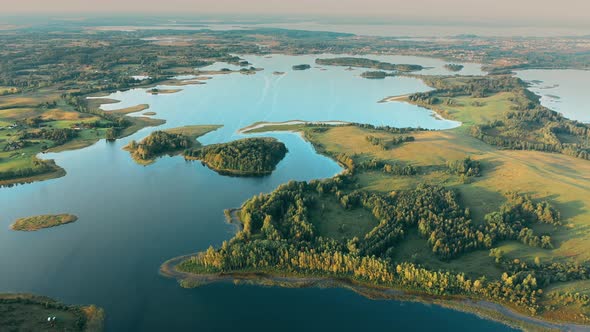 Aerial View Of Nedrava Lake And Green Forest Landscape In Sunny Summer Morning alt