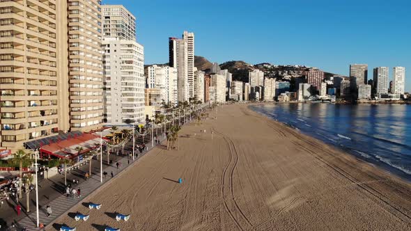 Aerial footage of Benidorm Playa Levante beach, hotels, buildings and restaurants