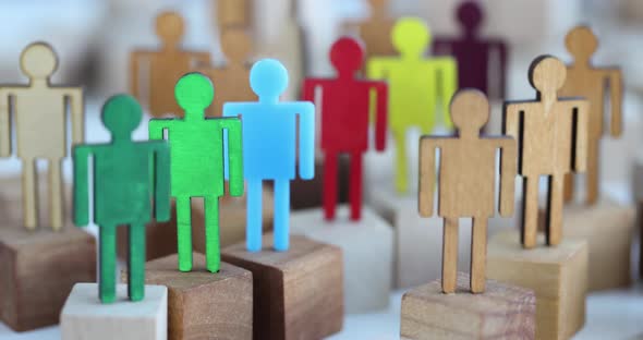 Multicolored Wooden Figurines in Crowd Closeup alt
