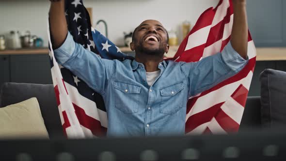 Front view video of extremely happy man with USA flag.  Shot with RED helium camera in 8K alt