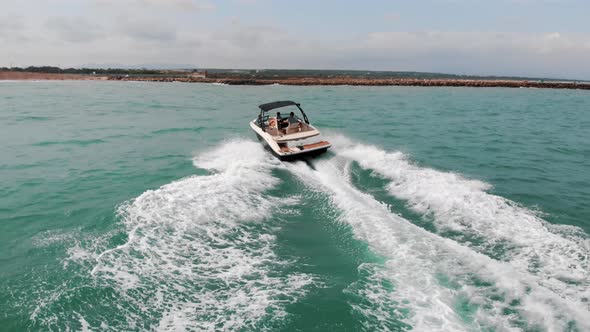 Speed Boat Sailing In The Calm Sea Making Foamy Waves Holidaymakers Having Fun alt