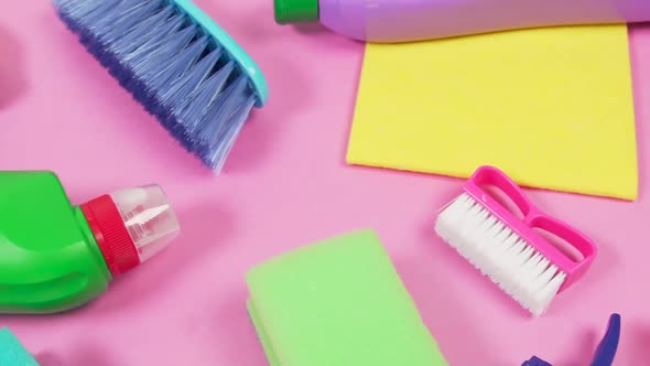 On a Pink Background are Items for Cleaning the House in Bright Colors