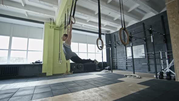 Woman Doing Pull-Us on Gymnastic Rings alt