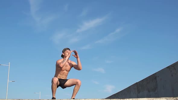 Fitness Man Squat Exercising Outdoors. Slow Motion