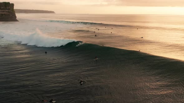 Following large waves at sunset