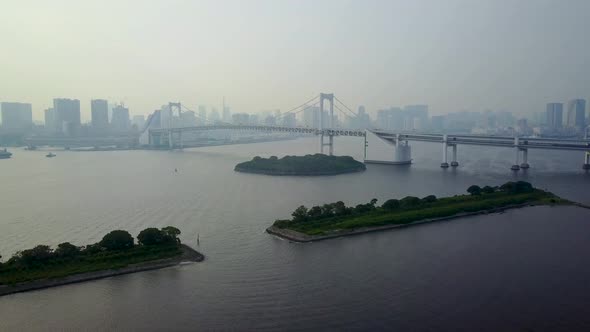 Aerial view of rainbow bridge at day time on water lowering alt