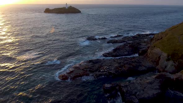Aerial view of Godrevy point lighthouse at seaside in Cornwall at sunset