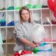 Woman Aerodesigner Stretches Air Clear Balloon with White Feathers Inside 