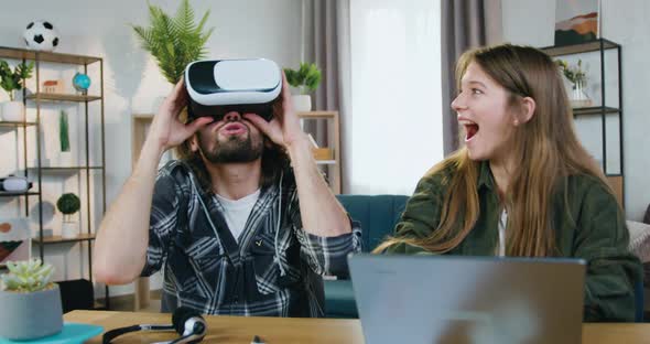 Smart Couple which Enjoying Virtual Reality Entertainment in Special 3d Glasses at Home alt