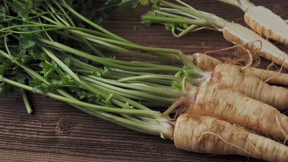 Heap roots parsley with leaves on wooden background 