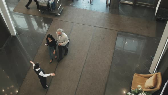 Couple Arriving in Posh Hotel alt