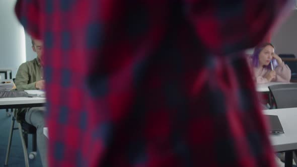 Students are Sitting in the Classroom and the Teacher is Listening the Student's Answer alt