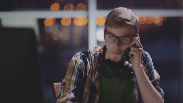 Freelancer Works Late at Night, Distracted By a Phone Call
