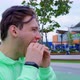 Stubble Guy Bites Off Chews Sandwich on Street - VideoHive Item for Sale