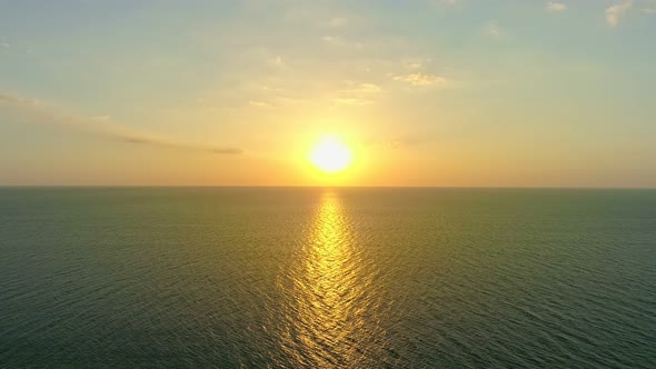 Aerial view Beautiful view sunset or sunrise over sea surface beautiful wave Amazing light twilight alt