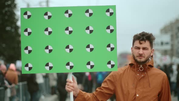 A Young Adult Activist Go Political Rally Banner in His Hands. Worker on Strike. alt