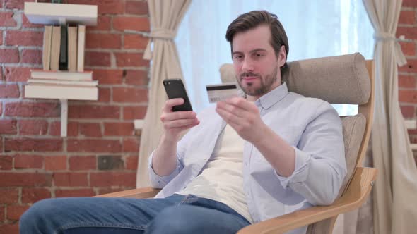 Casual Young Man Unsuccessful Online Payment on Smartphone alt