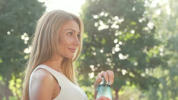 Beautiful Woman Enjoying Drinking Water After Outdoor Workout