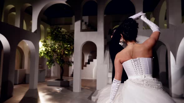 A Professional Dancing Couple During a Performance in a Dark Hall alt