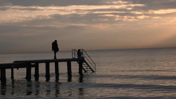 Young People Looking At The Sea And The Sunset alt