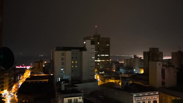 Timelapse of night to dawn in Asuncion, waking up with the streets and building lights changing thro alt