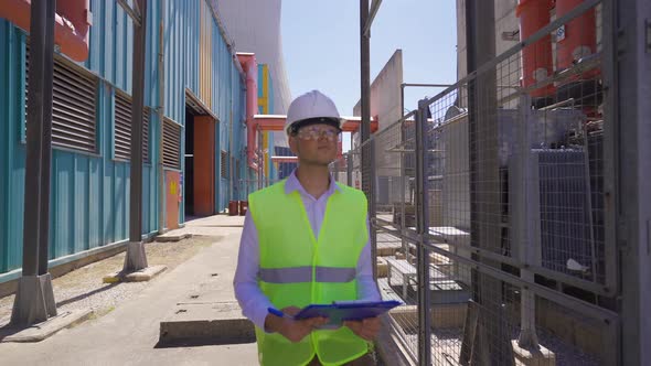 Engineer walking in high voltage field. alt