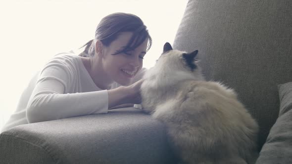 Woman cuddling her cat