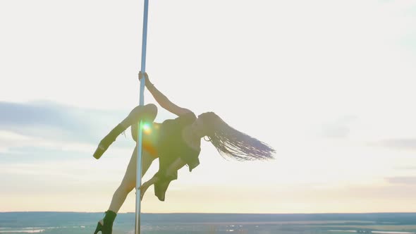 Pole Dance on Nature - Sexy Attractive Woman with Long Blue Braids in Black Dress Dancing on the alt