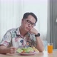 Man Holding His Cheek And Shaking Her Head Due To Hating Eating Healthy Food While Having A Meal - VideoHive Item for Sale