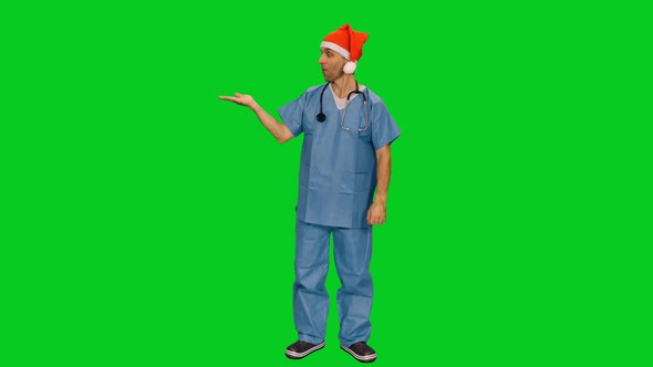 Medic in Santa Hat Doing Presentation with Copy Space on Green Screen