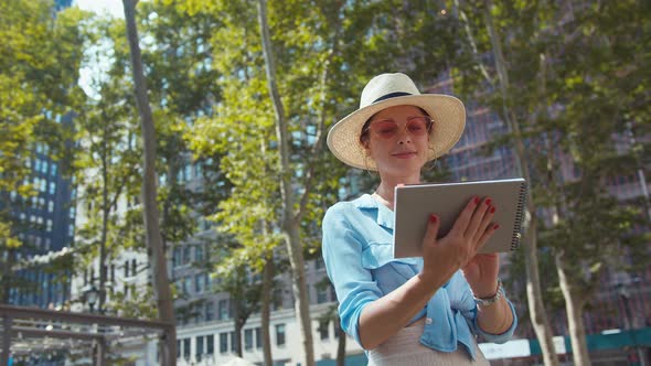 Smiling woman with a memorial book in New York alt