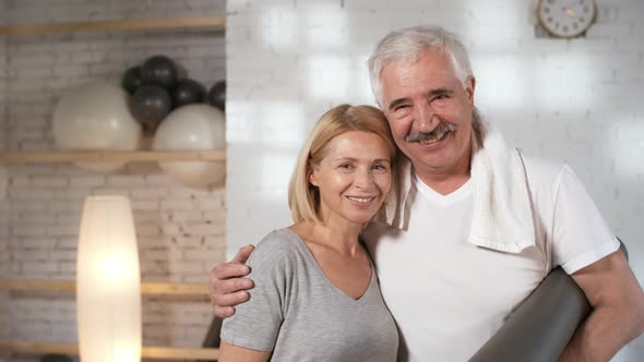Happy Mature Caucasian Owner Couple Posing in Their Yoga Studio alt