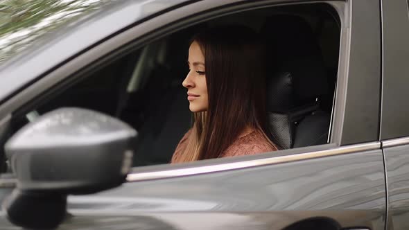 Young woman in car. Auto as present or gift at birthday