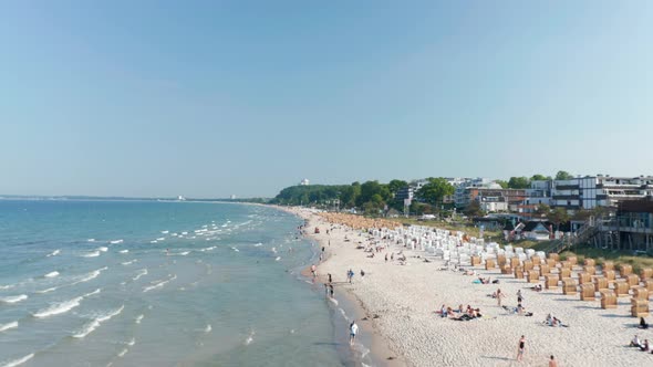 Waves Crashing Against Tourist Beach in Scharbeutz Germany Sunny Day alt