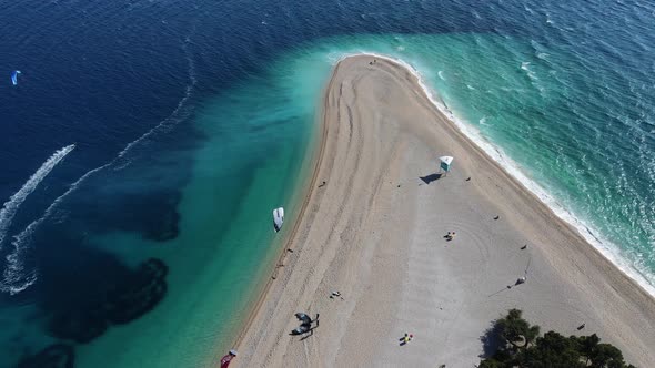 Paraglider that are preparing to surf at the golden horn beach in Croatia. alt