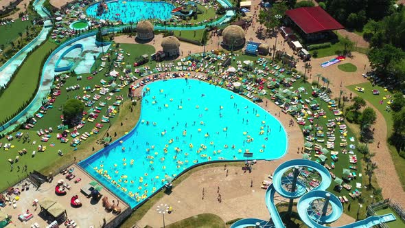 Top View of People Relaxing in the Pool on Yellow Inflatable Circles