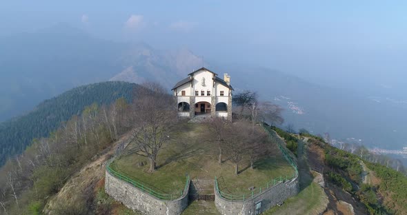 Aerial View of Mountain Peak During Autumn During Day with Building on Top