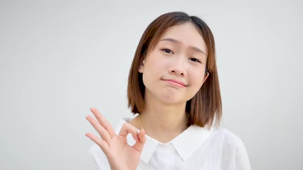 Asian girl doing okay gesture agreeing with a good idea