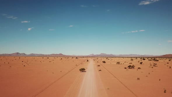 Namibian Gravel Road in Kalahari Desert in Africa. Aerial Drone Shot. Lanscape of the Road in the De alt
